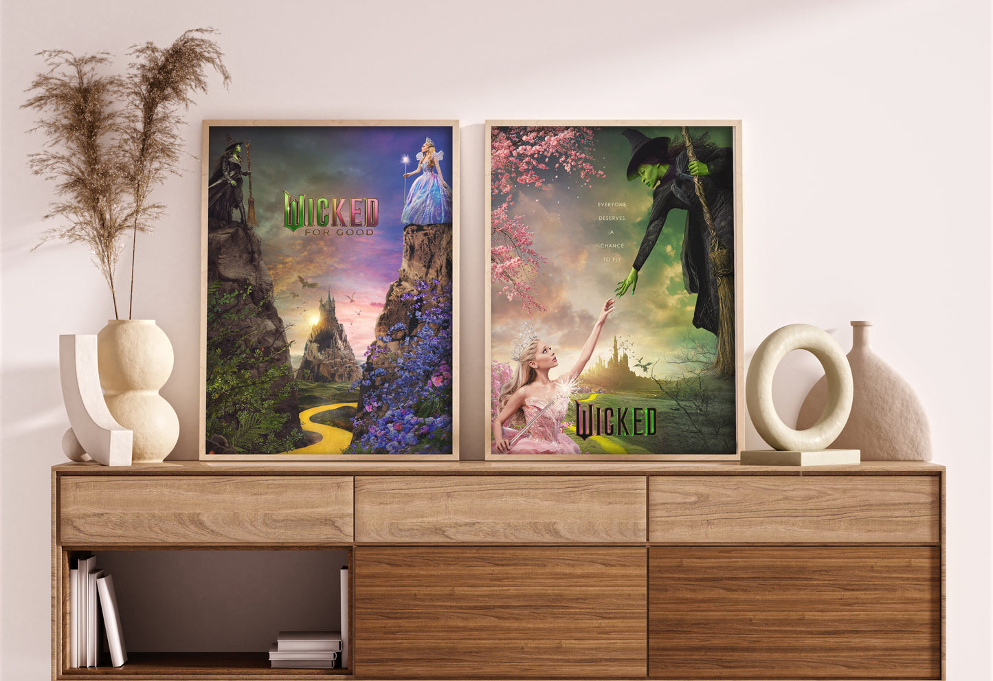 Two 'Wicked' themed posters on a wooden shelf with decorative items.