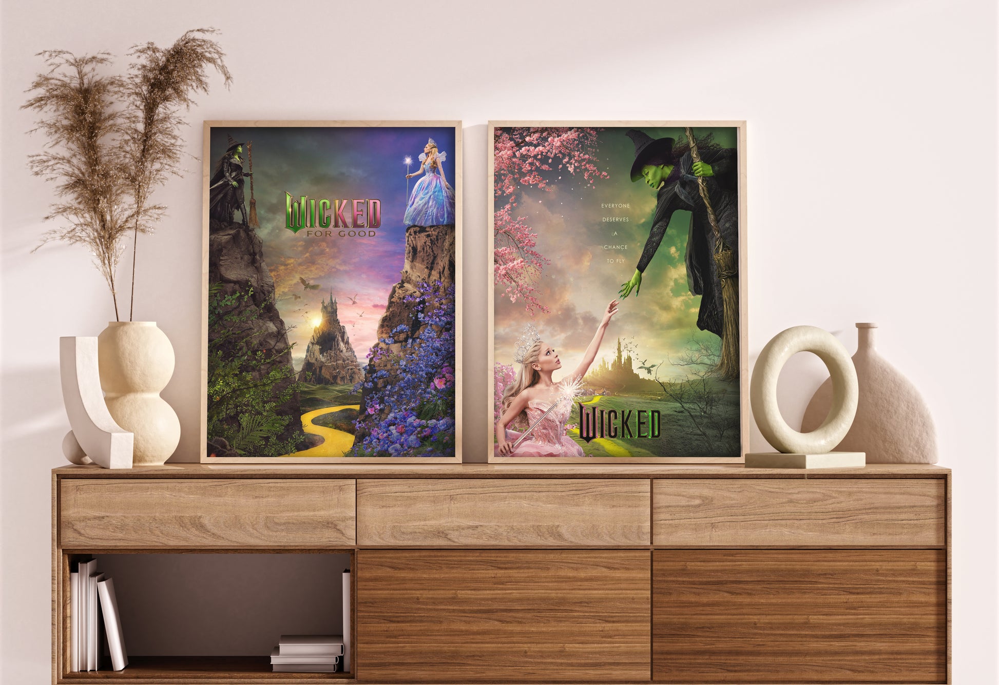 Two 'Wicked' themed posters on a wooden shelf with decorative items.