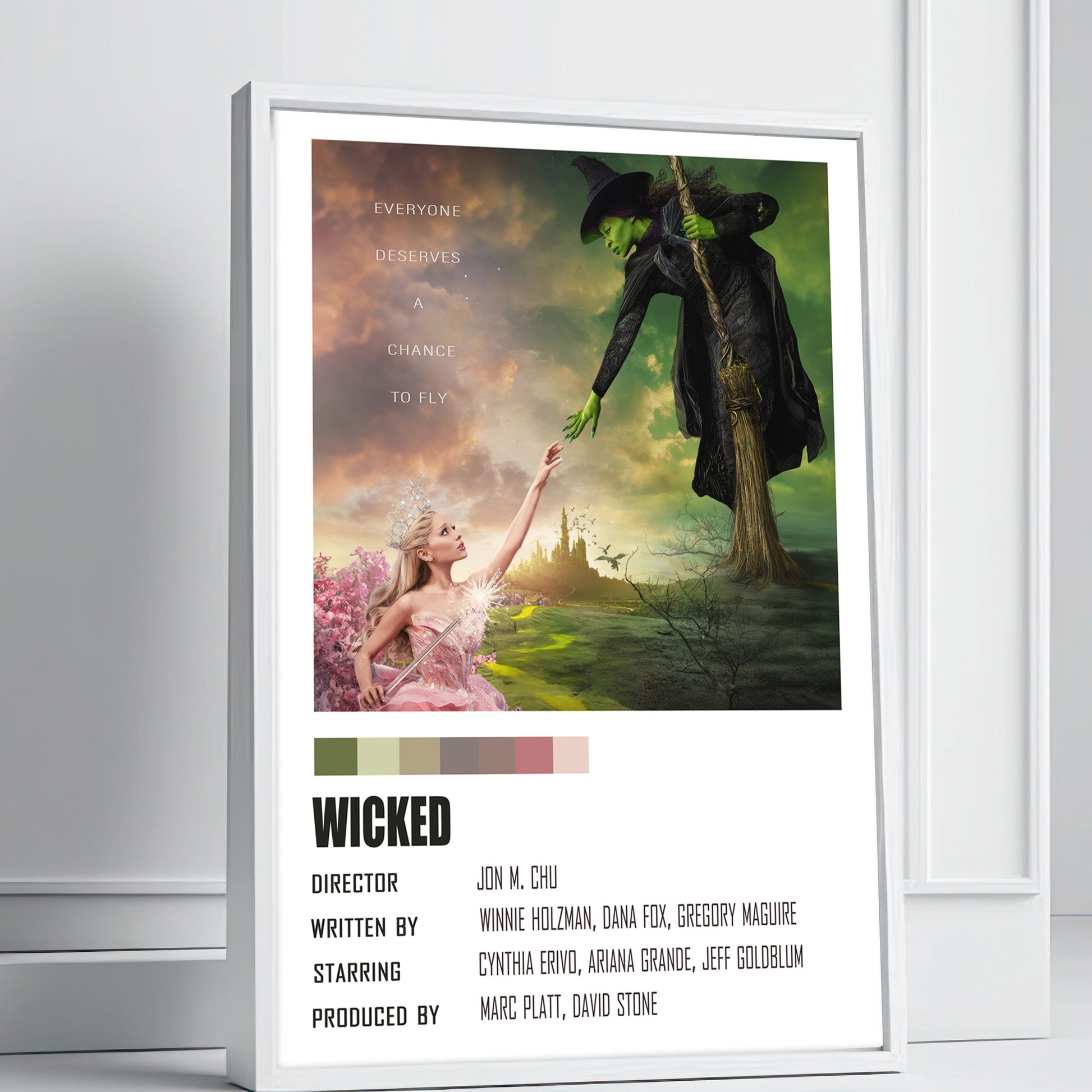 Framed 'Wicked' poster with colorful design on a white wall.